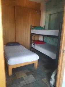 a room with two bunk beds and a table at hostal la playa vallarta in Puerto Vallarta