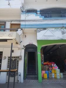 a building with a stairway leading into a store at hostal la playa vallarta in Puerto Vallarta
