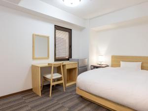 a hotel room with a bed and a desk and a table at Hotel Neo Rouge in Tokyo +78 photos