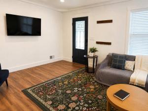 a living room with a couch and a flat screen tv at The Hangout House With Bonus Game Room & Foosball in Coeur d'Alene