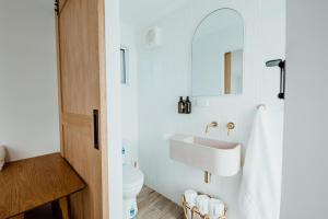 a bathroom with a sink and a toilet at The Floathouse - Floating tiny home on the Murray in White Sands +16 photos