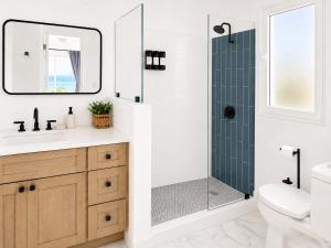 a bathroom with a shower and a toilet and a sink at The View at Green Cay - Full AC - Walk to the Beach in Christiansted