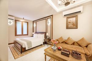 a bedroom with a bed and a couch at Phoum Chaufea Resort in Siem Reap +119 photos