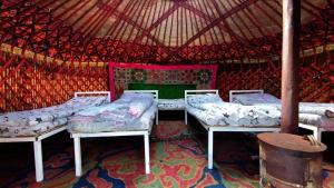 a room with three beds in a yurt at Yurtcamp Rahat&Horse Trekking in Kyzylemgek +59 photos