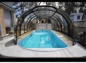 a swimming pool with an arch over it at RestCoast Villa in Shekhvetili