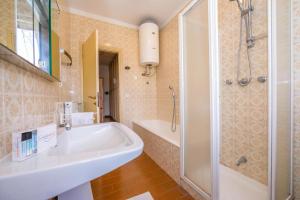 a bathroom with a tub and a shower and a sink at Margherita near lake - Family Friendly - Happy Rentals in Toscolano Maderno