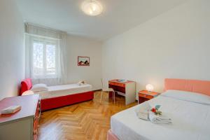 a room with two beds and a table and a desk at Margherita near lake - Family Friendly - Happy Rentals in Toscolano Maderno +31 photos