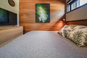 a bedroom with a bed and a flat screen tv at Levi Platinum Aurora in Levi