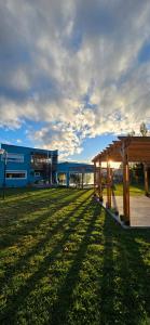 a building with a pavilion in the middle of a field at Alojamiento Amado in Los Antiguos