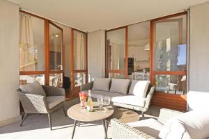 a living room with a couch and chairs and a table at Casa Rinetta with Patio and A/C - Happy Rentals in Lugano