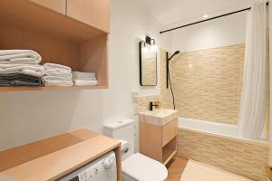 a bathroom with a toilet and a sink and a shower at Casa Rinetta with Patio and A/C - Happy Rentals in Lugano