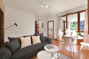 a living room with a couch and a table at Casa Rinetta with Patio and A/C - Happy Rentals in Lugano +12 photos
