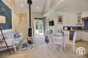 a kitchen and a living room with a table at Le murmure des oiseaux in Plussulien +26 photos