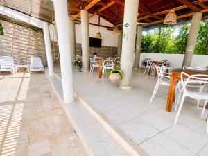a patio with tables and chairs in a building at Apartasuite tolu in Tolú