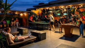a group of people playing a game in a bar at Pariwana Hostel Lima in Lima