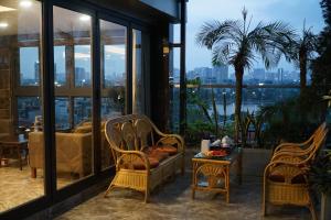 a patio with chairs and a table with a view at Luxor Boutique Hotel in Hanoi