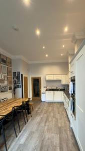 a large kitchen with a wooden table and chairs at Rutland Home in Langham