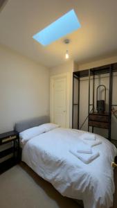 a bedroom with a large bed with a blue light at Rutland Home in Langham