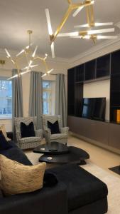 a living room with a couch and a tv at Rutland Home in Langham