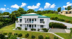 an aerial view of a white house on a hill at The View at Green Cay - Full AC - Walk to the Beach in Christiansted