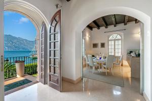 a dining room with a table and a view of the ocean at Villa Schlosser Lake Front & Private Pool in Malcesine