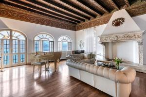an ornate living room with a fireplace and a piano at Villa Schlosser Lake Front & Private Pool in Malcesine