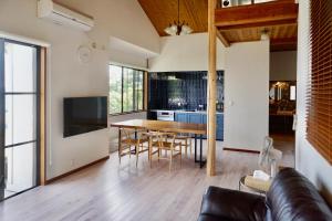 a kitchen and dining room with a table and chairs at 海を望む東伊豆の一棟貸し ula Ocean-view private stay in Izu in Higashiizu