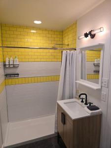 a bathroom with a sink and a tub and a shower at Stylish Apt in Walker's Point in Milwaukee +6 photos