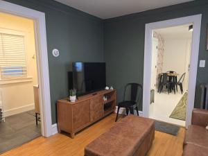a living room with a couch and a television at Stylish Apt in Walker's Point in Milwaukee