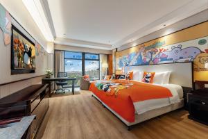 a bedroom with a large orange bed and a desk at Howard Johnson Jinyi Hotel Chongqing in Chongqing +33 photos