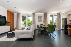 a living room with a couch and a table at Villa Nika with pool & parking near Zadar in Bibinje