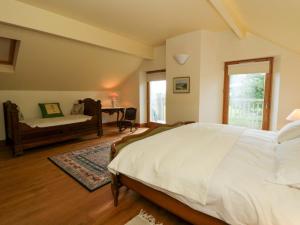 a bedroom with a bed and a desk and a window at Bryn Isaf in Ystrad Meurig