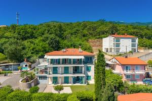 a large white house with an orange roof at Beachside Villa Mia Apartments in Medveja