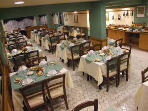 a dining room with tables and chairs with food on them at Hotel Internacional in San Carlos de Bariloche