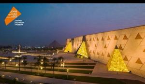 a view of a building at night with pyramids at Pyramids Heritage suites in Ghaţāţī
