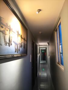 a hallway with two paintings on the wall and a hallway sidx sidx sidx at Hoài Thu Luna Hotel in Ðông Hòa +19 photos