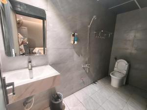 a bathroom with a sink and a shower and a toilet at Hoài Thu Luna Hotel in Ðông Hòa