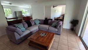 a living room with a couch and a coffee table at Peaceful Country Home Between Brisbane & GC in Wolfdene