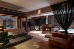 a bedroom with a bed and a fireplace at Luxury Villa Christina in Makrygialos +63 photos