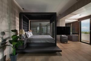a bedroom with a bed and a large window at Luxury Villa Christina in Makrygialos