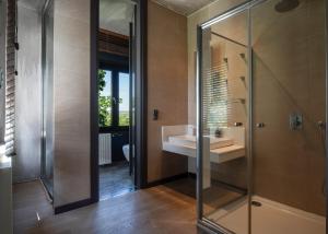 a bathroom with a glass shower and a sink at Luxury Villa Christina in Makrygialos