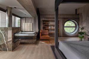 a bedroom with a bed and a desk at Luxury Villa Christina in Makrygialos
