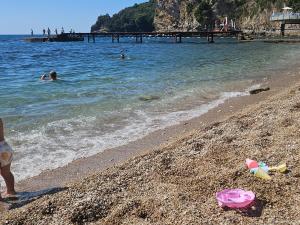 a group of people swimming in the water at the beach at Old town Budva D&M in Budva