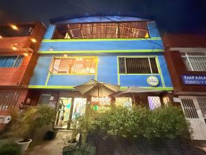 a blue building with an umbrella in front of it at Bababuy Hostel in Bogotá