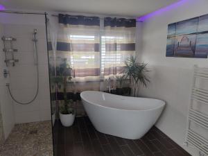 a bathroom with a large tub and a shower at FeWo - bei Tati 95qm in Singen +34 photos