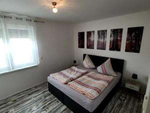 a bedroom with a bed with two pillows on it at Ferienwohnung Schmidt mit Terrasse in Neustrelitz