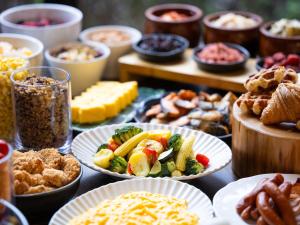 a table with plates of food and bowls of food at Chisun Grand Takayama in Takayama