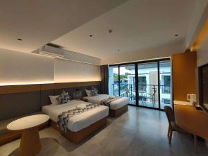 two beds in a hotel room with a balcony at Diver's home resort in Panglao Island +98 photos