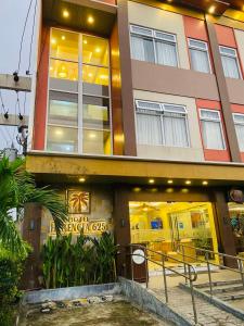 a building with a sign in front of it at Hotel Herencia 625 in Locsin
