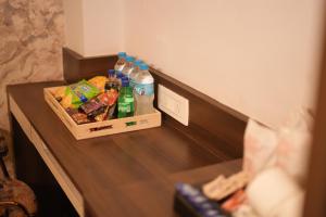 a counter with bottles of water and snacks on it at Sanidhyam by Hotel Sahu near Temple in Varanasi
